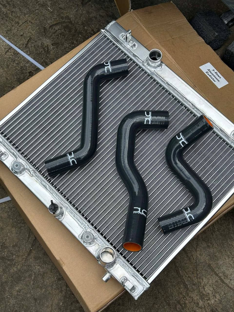 DLC aluminum radiator with black branded silicone hoses