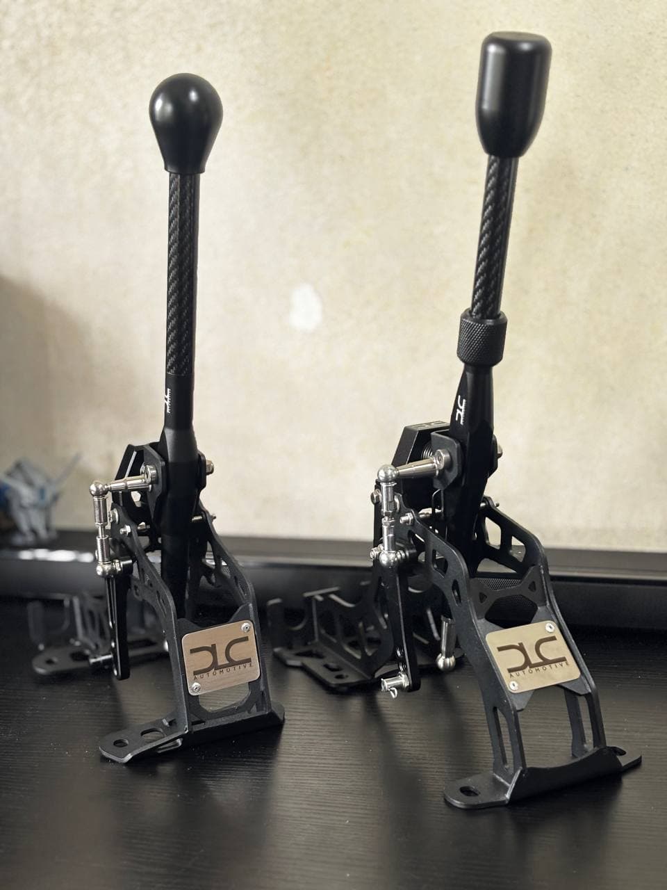 Two DLC Automotive short shift kits displayed side by side